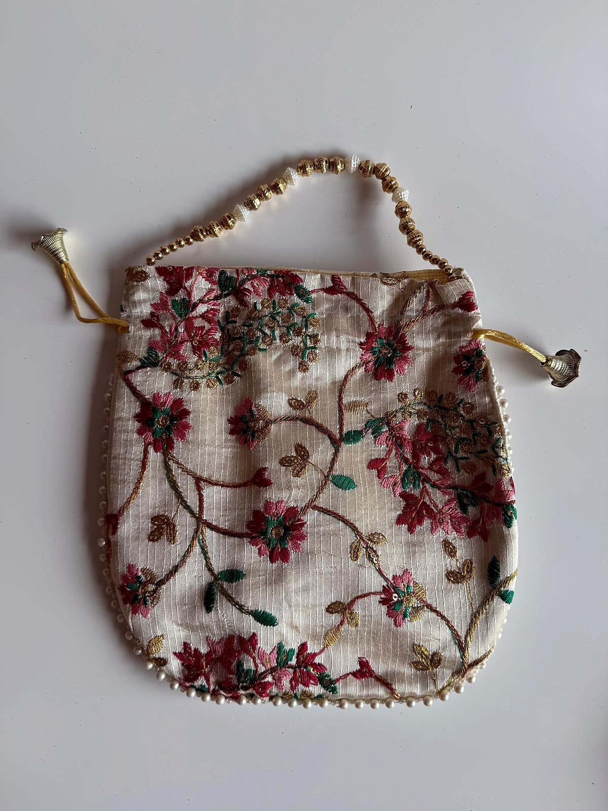 Front view of ivory potli bag with beaded handle