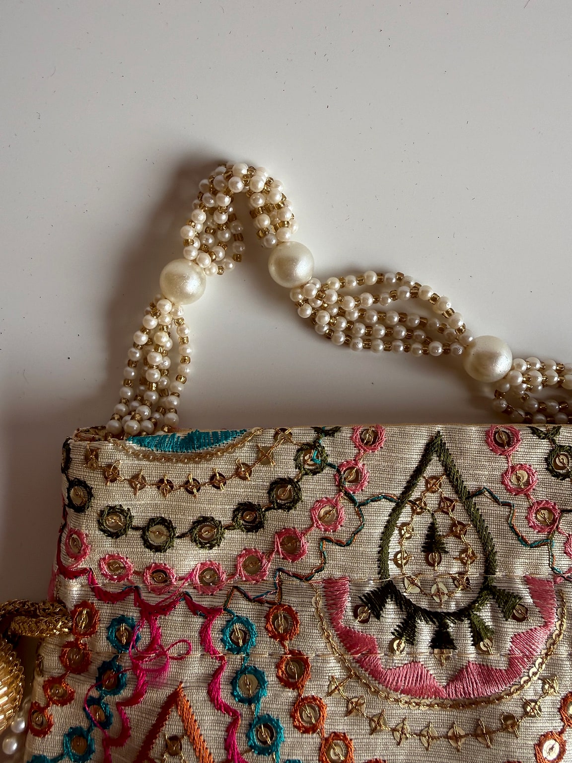 Top view of potli bag showcasing pearl handle
