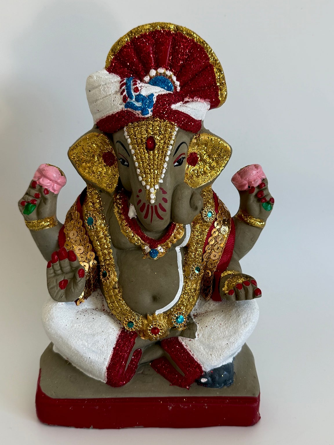 Close-up of Ganesh idol's intricate face and embellishments