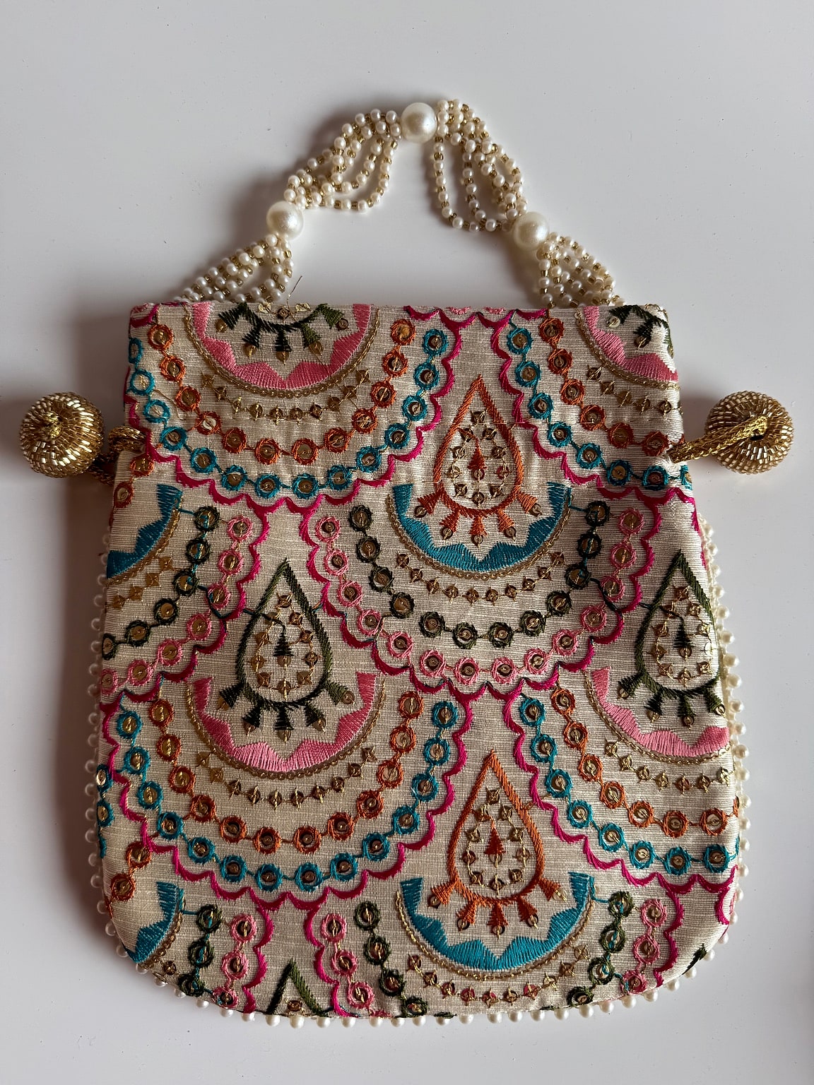 Multicolor embroidered potli bag with pearl handle