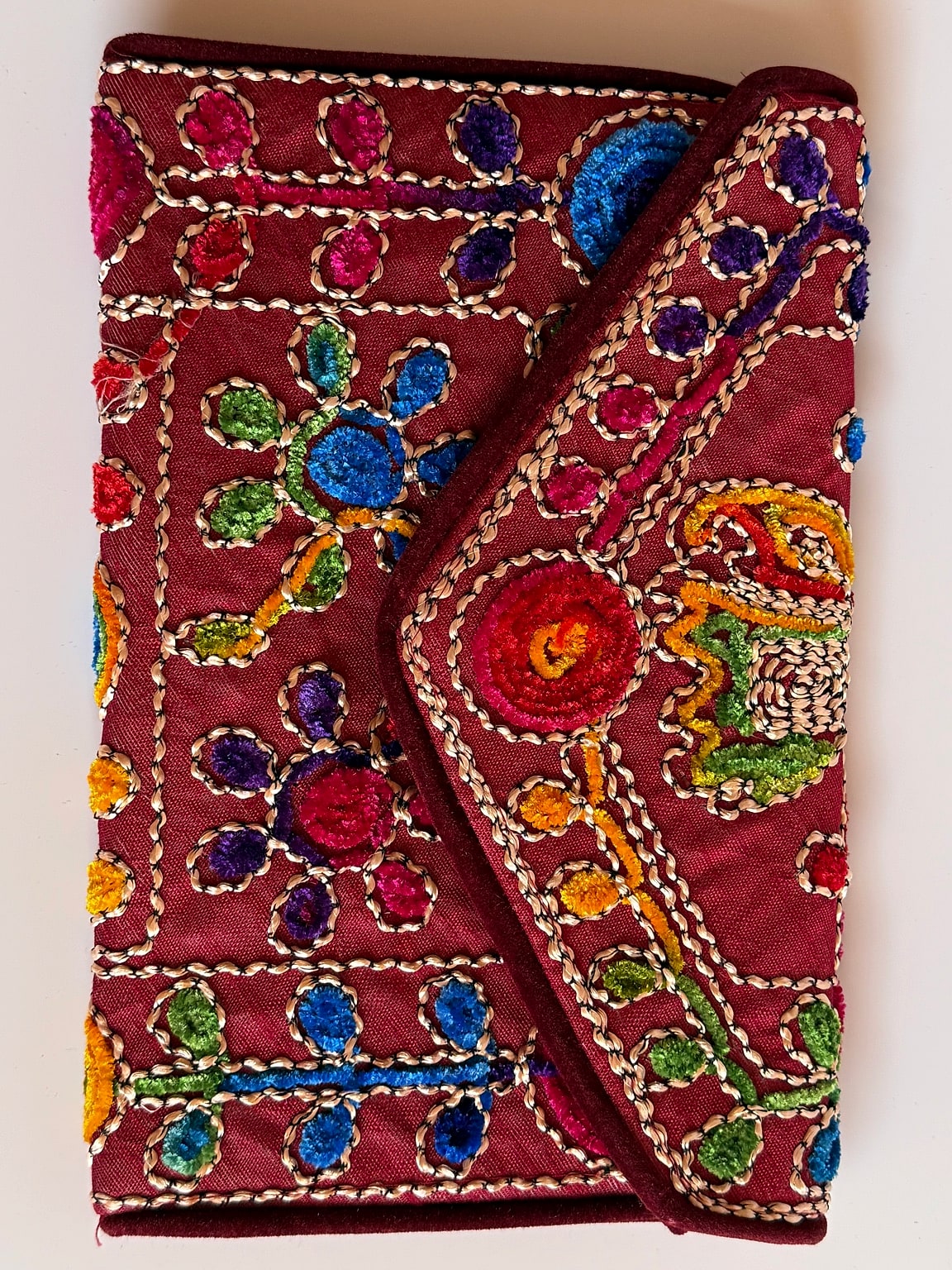 Front view of multicolor embroidered potli bag with intricate design