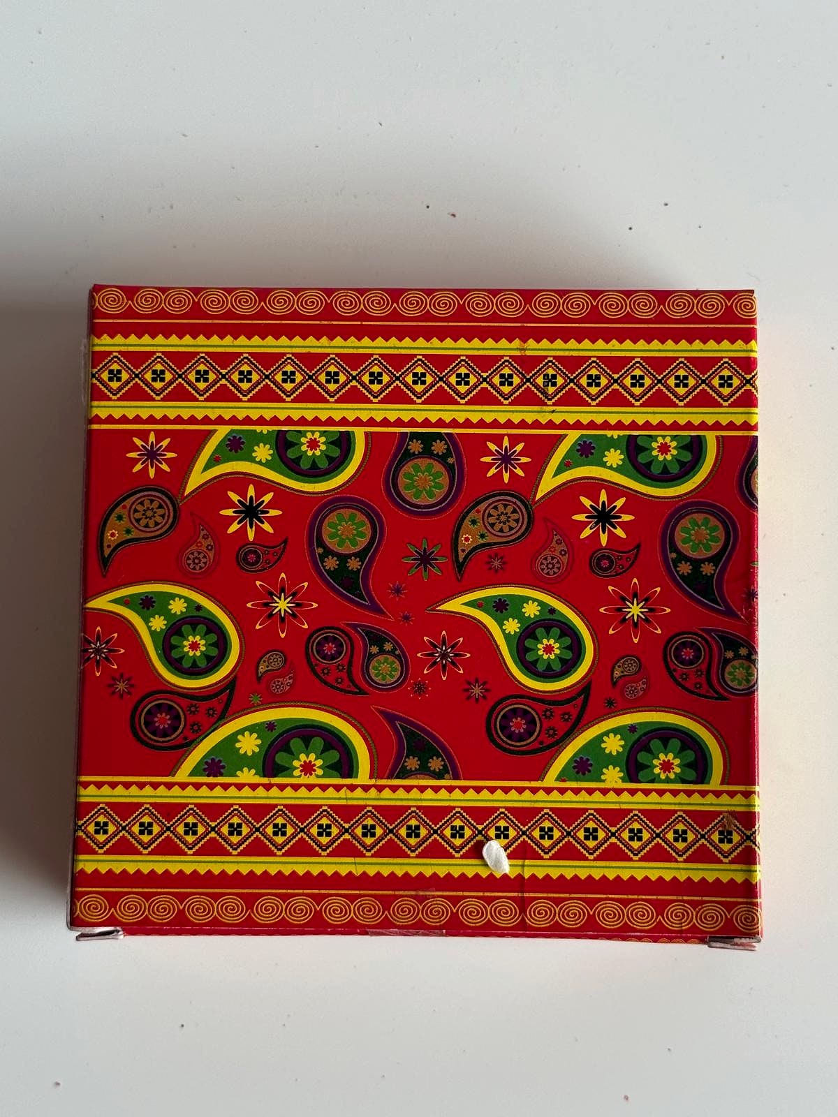 Close-up of vibrant paisley design on the box
