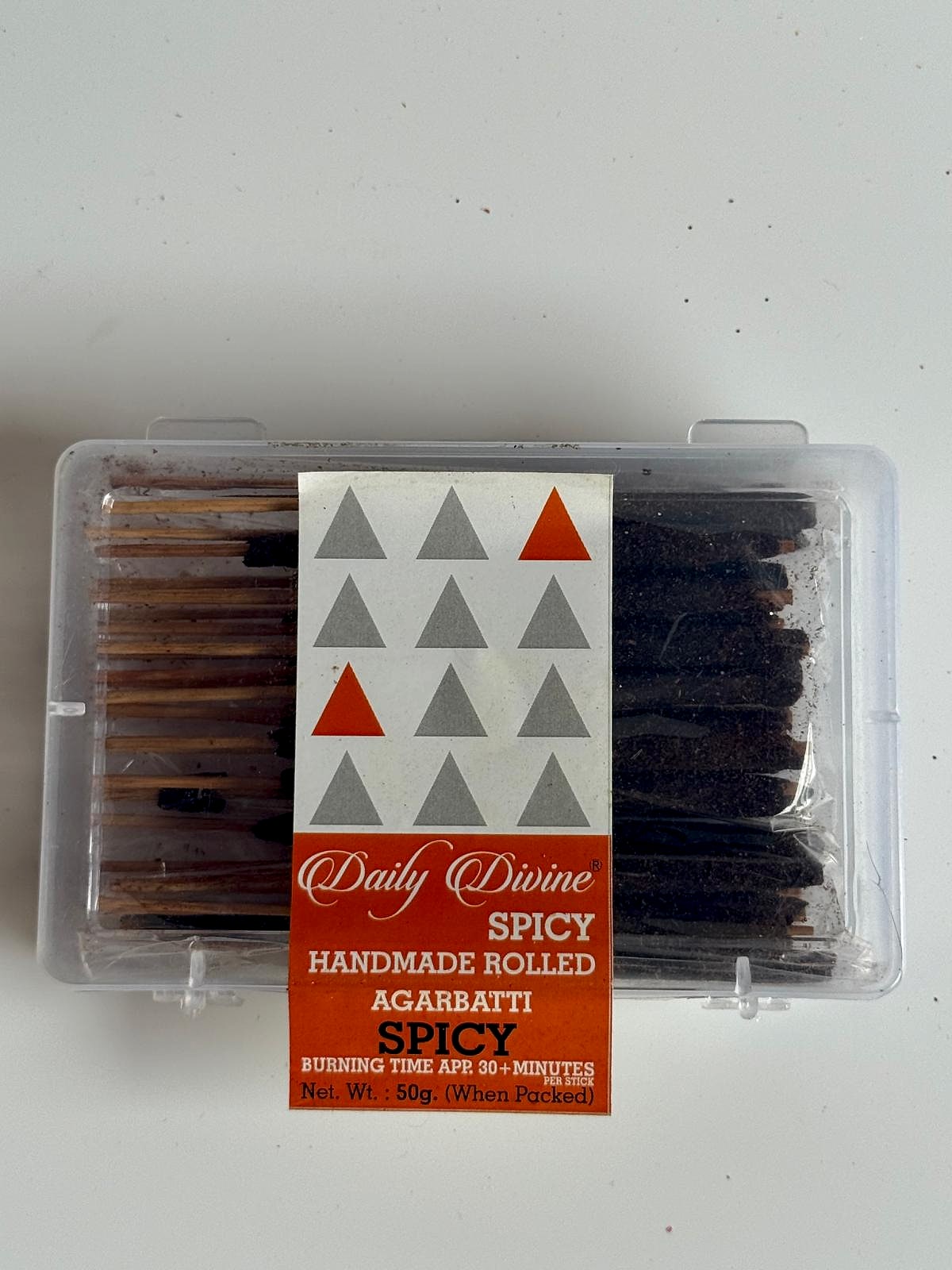 Top view of the plastic box showcasing tightly packed handmade incense sticks