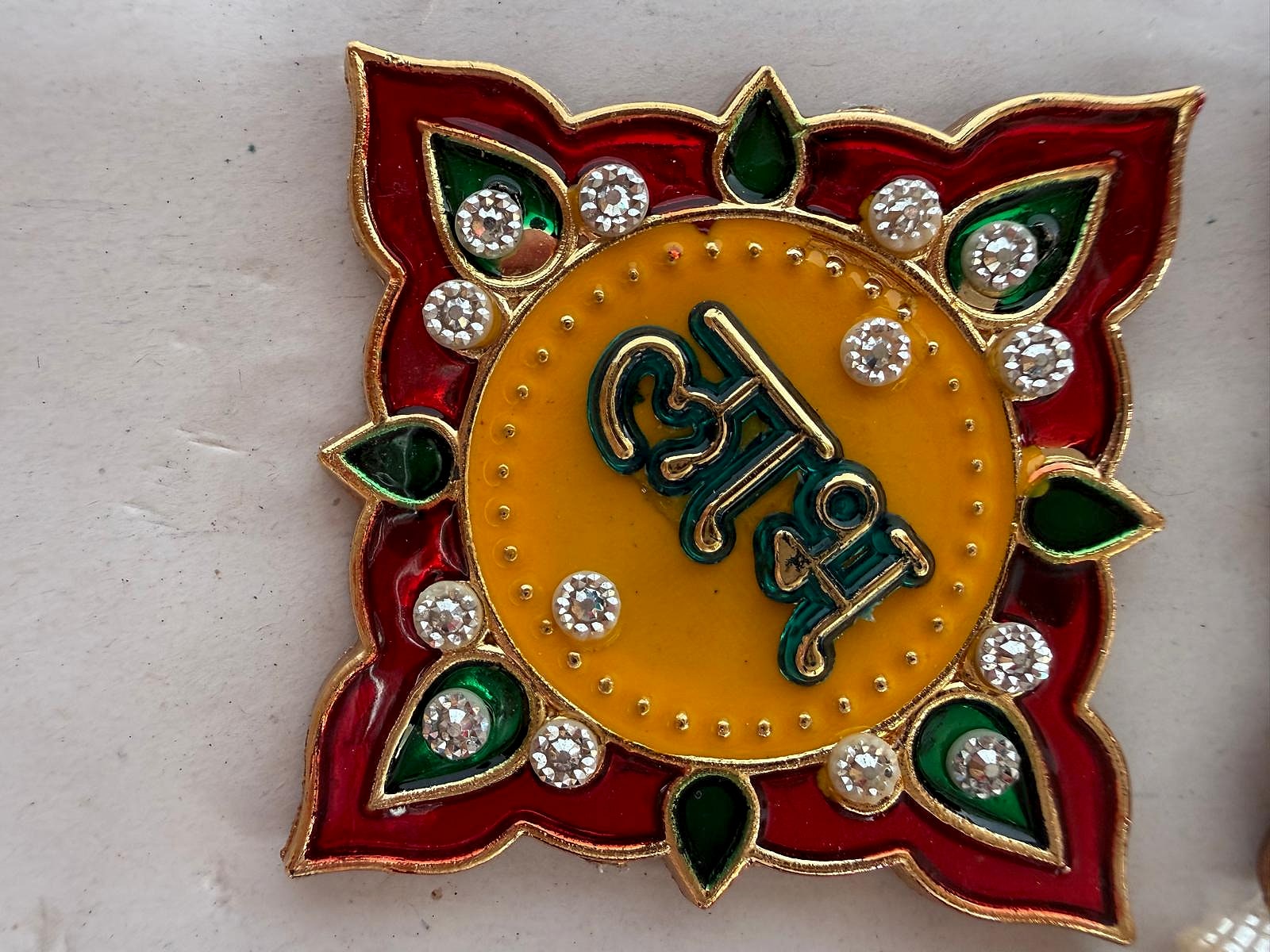 Close-up of Shubh Labh motif with sparkling gemstones