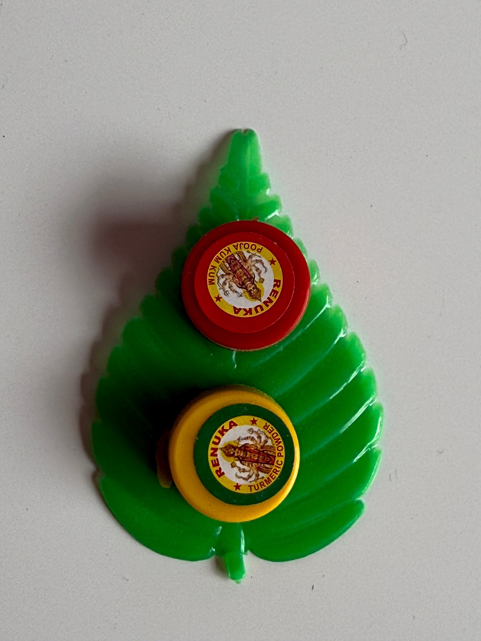 Leaf-shaped holder showcasing vibrant green color and small compartments